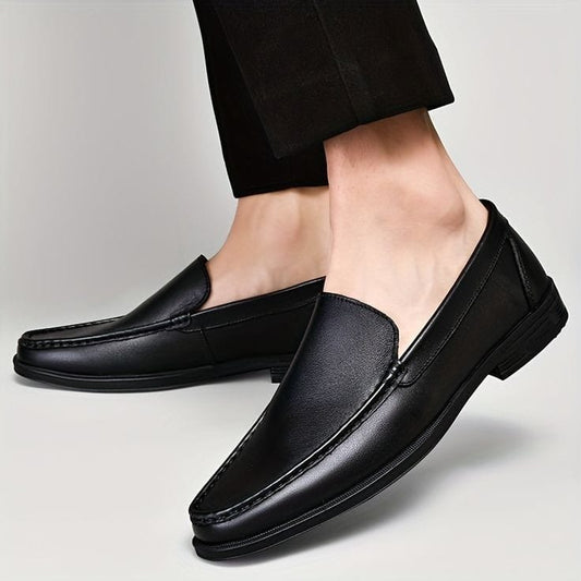 A person wearing brown formal shoes with a simple design.